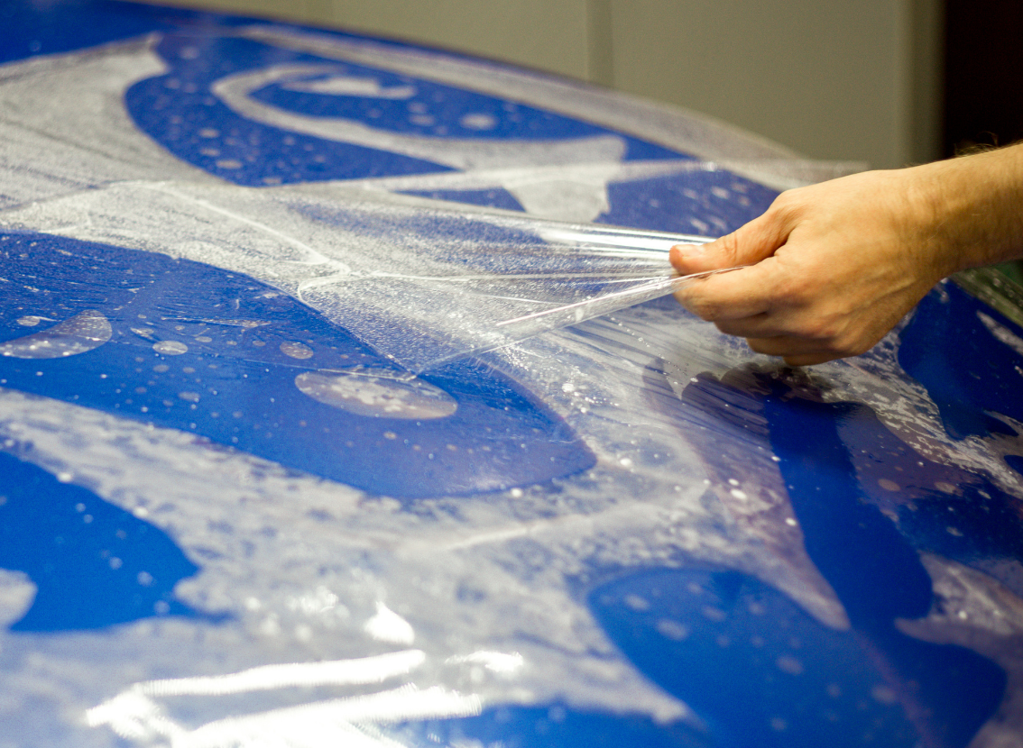 Paint protection film being installed on a Tesla in Dubai
